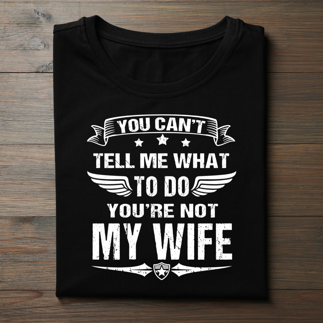 Black t-shirt with white text on a wooden surface