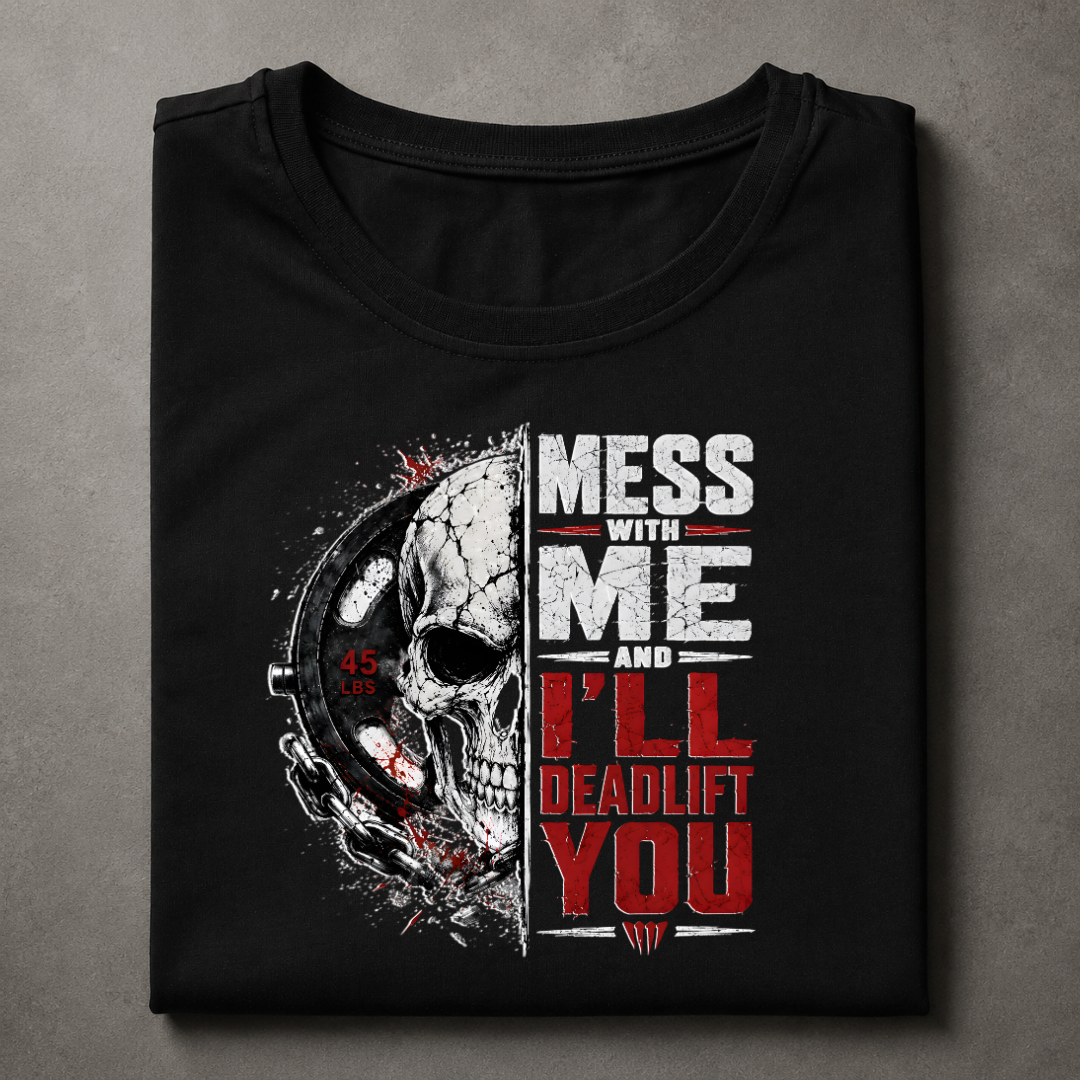A folded black t-shirt with a graphic print featuring a skull and the text 'MESS WITH ME AND I'LL DEADLIFT YOU' in distressed white and red lettering, displayed on a textured gray background.
