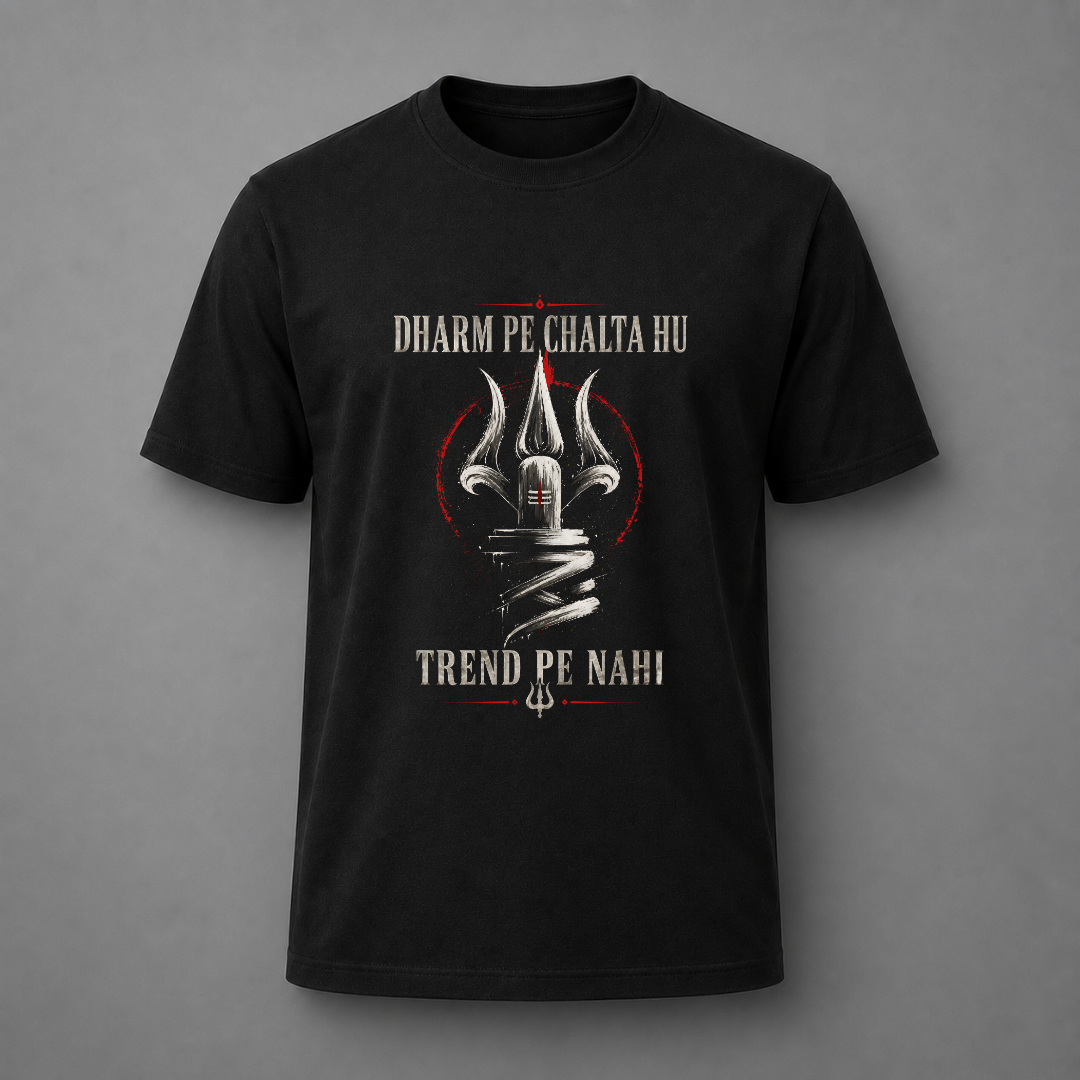 A black short-sleeve t-shirt with a graphic print featuring a silver trident, a red circular outline, and white text reading 'DHARM PE CHALTA HU' and 'TREND PE NAHI' on a gray background.
