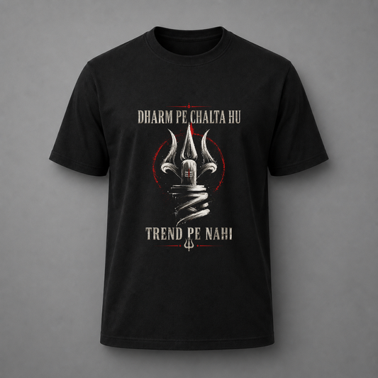 A black short-sleeve t-shirt with a graphic print featuring a silver trident, a red circular outline, and white text reading 'DHARM PE CHALTA HU' and 'TREND PE NAHI' on a gray background.