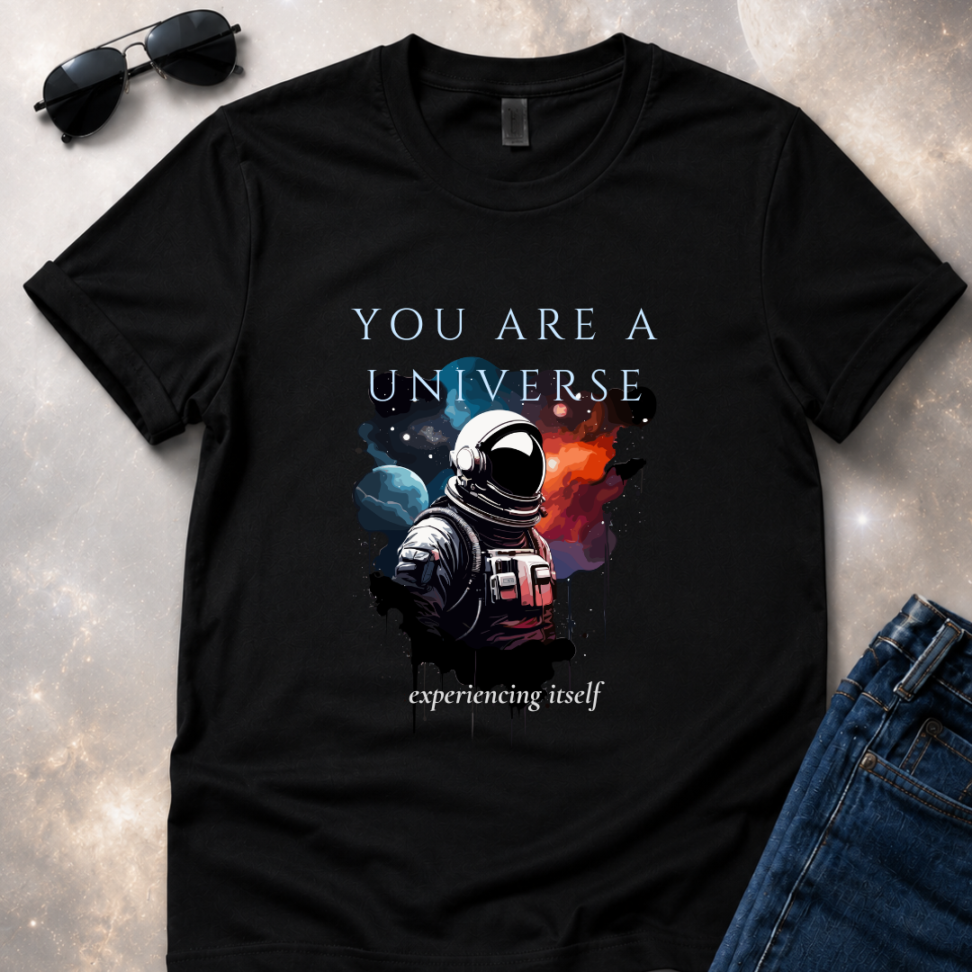 a unfolded black t-shirt with an astronaut graphic and text 'You are a universe experiencing itself'.