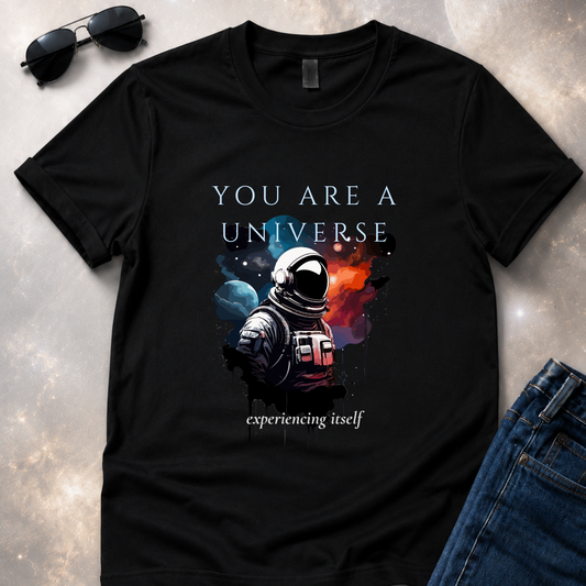 a unfolded black t-shirt with an astronaut graphic and text 'You are a universe experiencing itself'.