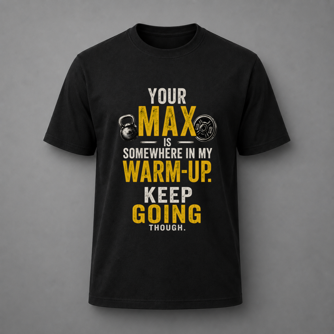 A black short-sleeve crewneck t-shirt with a motivational graphic on the front. The graphic features the text 'YOUR MAX IS SOMEWHERE IN MY WARM-UP.