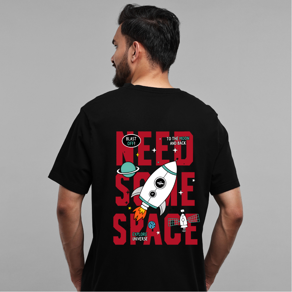 Person wearing a black t-shirt with a space-themed design on the back.