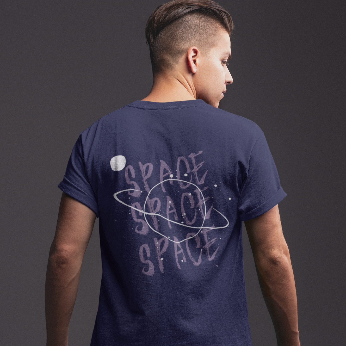 Person wearing a navy blue t-shirt with 'SPACE' text on the back against a dark background