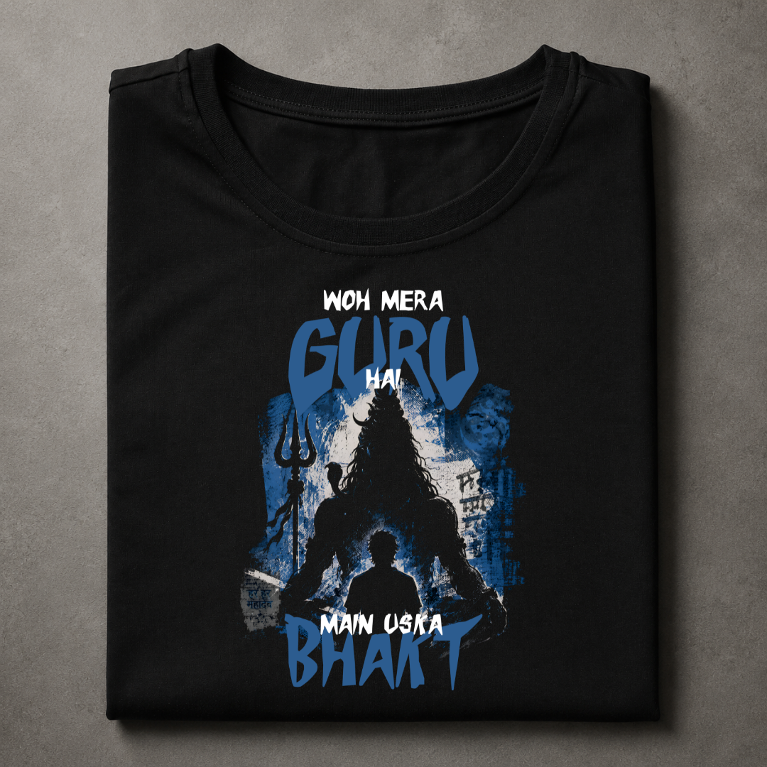 A folded black t-shirt with a blue and white graphic print featuring a silhouette of a guru and the text 'WOH MERA GURU HAI MAIN USKA BHAKT', displayed on a textured gray background.